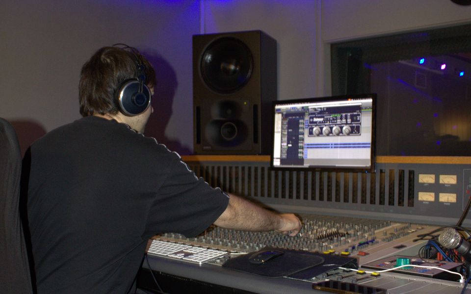 Yorch con cascos trabajando en la consola, con el proyecto en pantalla